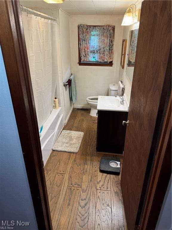 920 Caywood Rd, Marietta, OH 45750 - full bathroom featuring toilet, shower / tub combo, wood finished floors, and vanity
