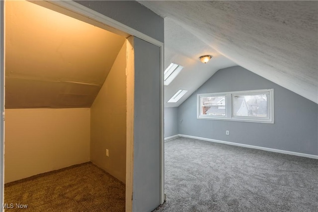 bonus room featuring a textured ceiling, baseboards, vaulted ceiling, and carpet flooring