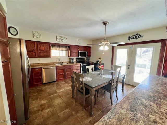 dining room featuring french doors, a wealth of natural light, and a ceiling fan