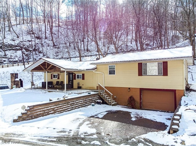 view of front of home with a porch and an attached garage