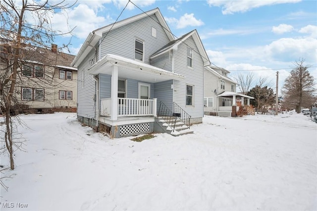 snow covered house with covered porch