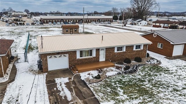 snowy aerial view with a residential view