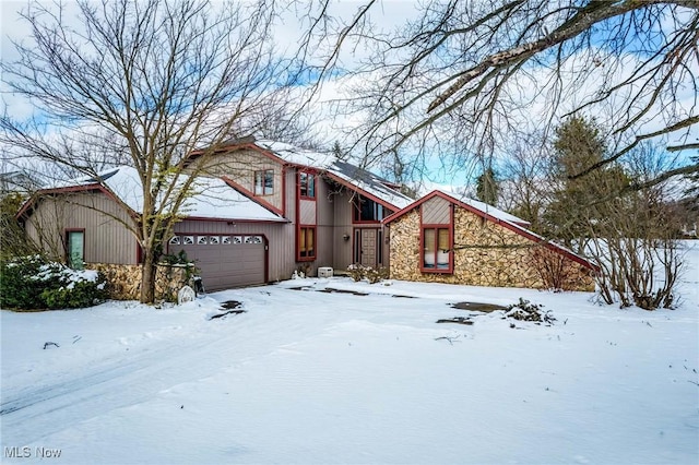 view of front of house with a garage and stone siding