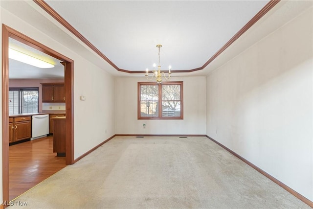 unfurnished room with crown molding, an inviting chandelier, a raised ceiling, and baseboards