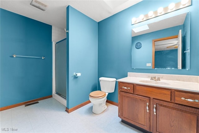 bathroom with a stall shower, baseboards, visible vents, toilet, and vanity