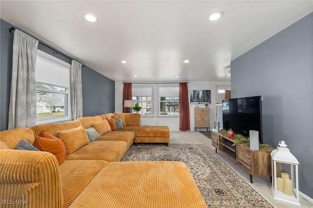 living area with recessed lighting, a wealth of natural light, and light colored carpet