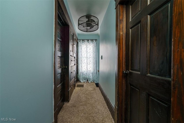 hallway with carpet and baseboards