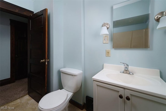 bathroom featuring toilet and vanity