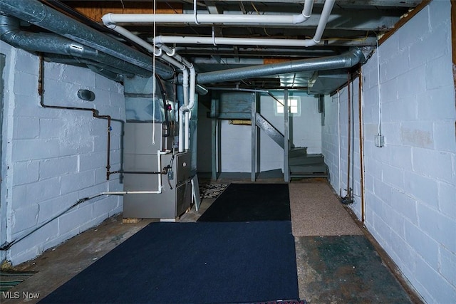 below grade area with heating unit and stairway