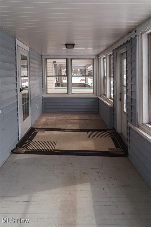 unfurnished sunroom featuring a wealth of natural light