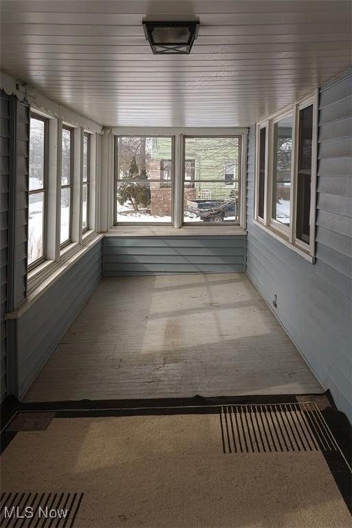 unfurnished sunroom featuring wooden ceiling