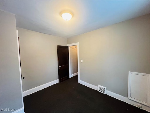 empty room featuring visible vents and baseboards