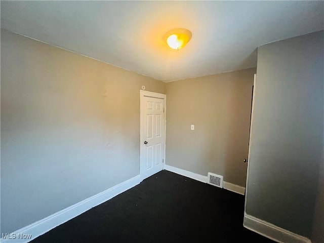 empty room with visible vents and baseboards