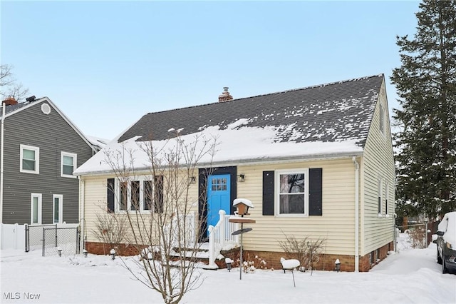 view of front of property featuring a chimney and fence