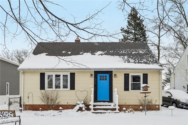 view of front of home with entry steps and a chimney