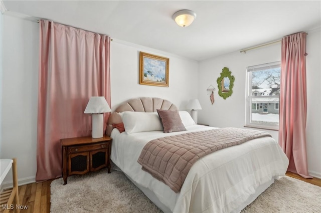 bedroom featuring light wood-style flooring and baseboards