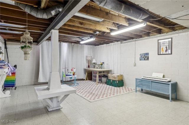 unfinished below grade area with concrete block wall and tile patterned floors