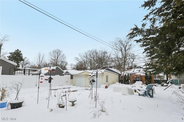 yard covered in snow with a residential view and fence