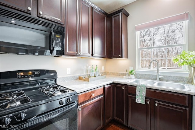 kitchen featuring black appliances and a sink