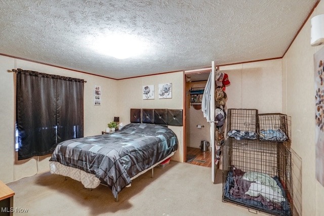 bedroom featuring carpet floors, crown molding, and a textured ceiling