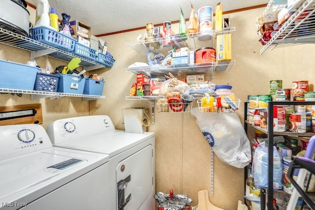 laundry room featuring laundry area, a textured ceiling, and washer and dryer