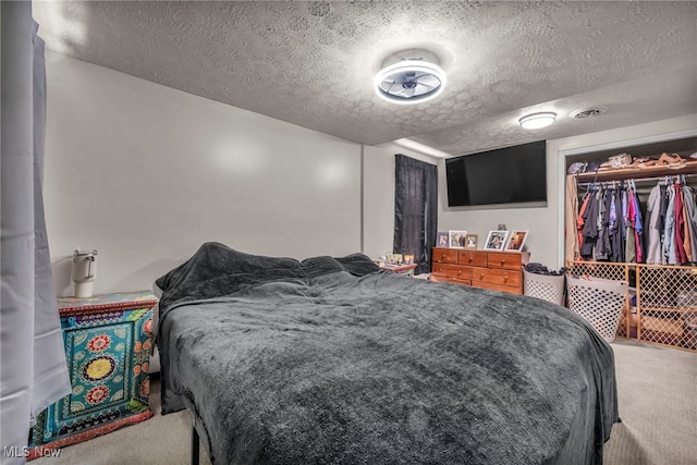 carpeted bedroom with a closet, visible vents, and a textured ceiling