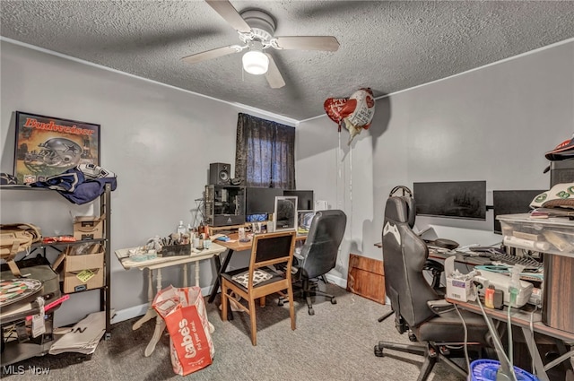 office space featuring a textured ceiling, carpet floors, ceiling fan, and baseboards