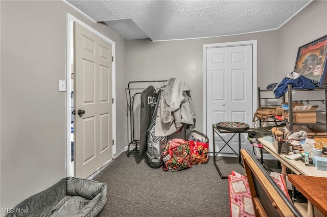 interior space with dark colored carpet and a textured ceiling