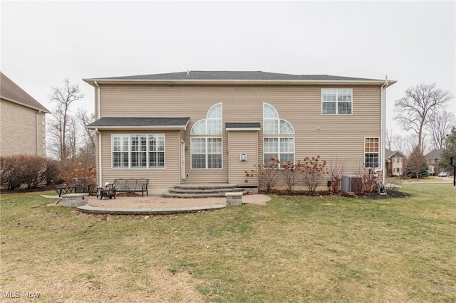 rear view of house with a yard, entry steps, and a patio