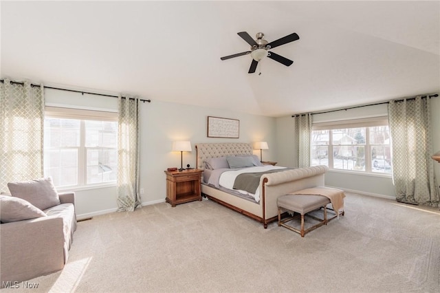 bedroom with baseboards, vaulted ceiling, a ceiling fan, and light colored carpet