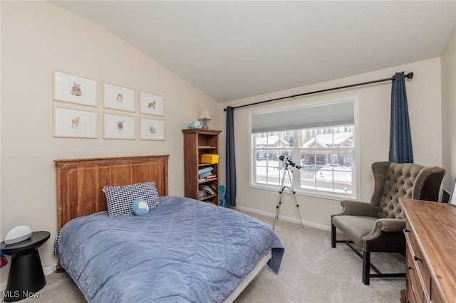 bedroom featuring lofted ceiling, light carpet, and baseboards