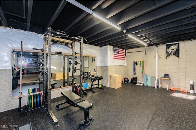 exercise room with brick wall