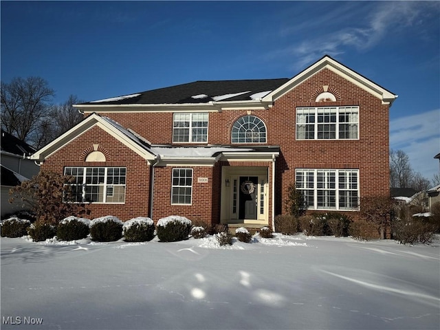 traditional-style home featuring brick siding