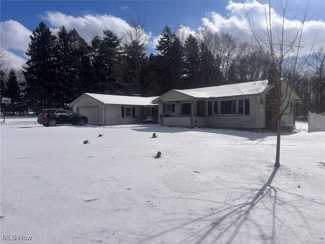 single story home featuring an outbuilding