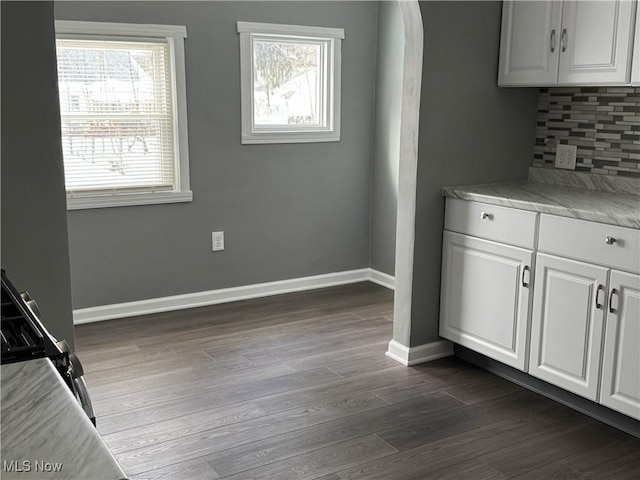 interior space with light countertops, a healthy amount of sunlight, and white cabinets