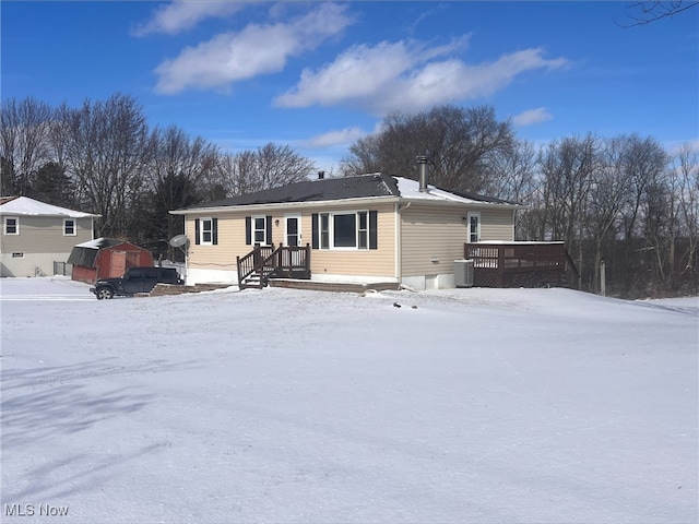 view of front of property featuring cooling unit and a wooden deck