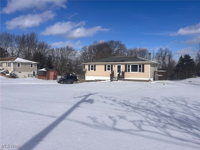 view of front of home featuring central AC, a shed, and an outdoor structure