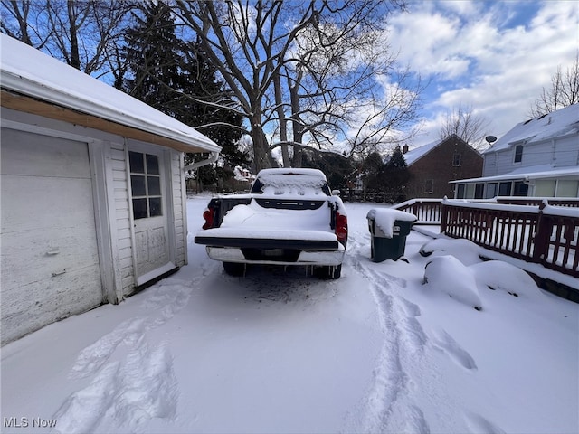 yard layered in snow featuring a wooden deck