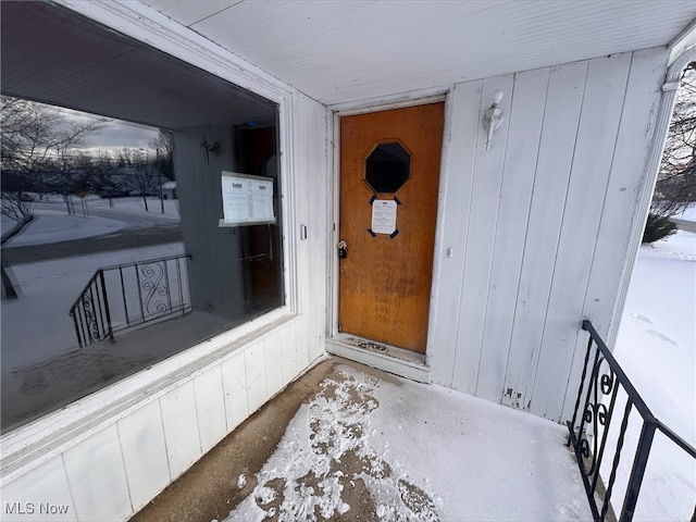 view of snow covered property entrance