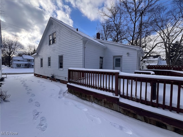 exterior space featuring a chimney and a deck