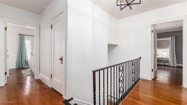 corridor with dark wood-style floors and baseboards