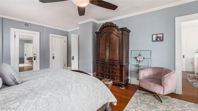 bedroom with baseboards, dark wood finished floors, ceiling fan, ornamental molding, and ensuite bathroom