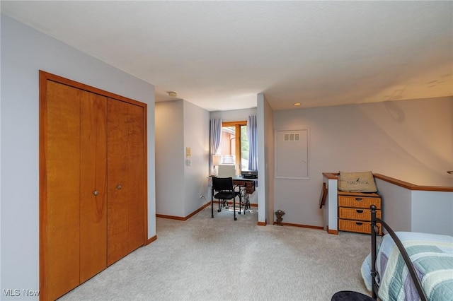 bedroom featuring light carpet, a closet, visible vents, and baseboards