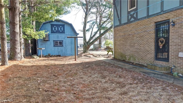 view of property exterior with an outbuilding and brick siding