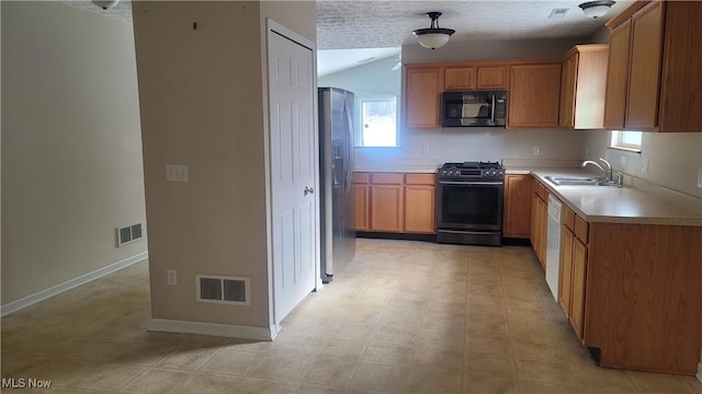 kitchen featuring light countertops, visible vents, appliances with stainless steel finishes, a sink, and plenty of natural light