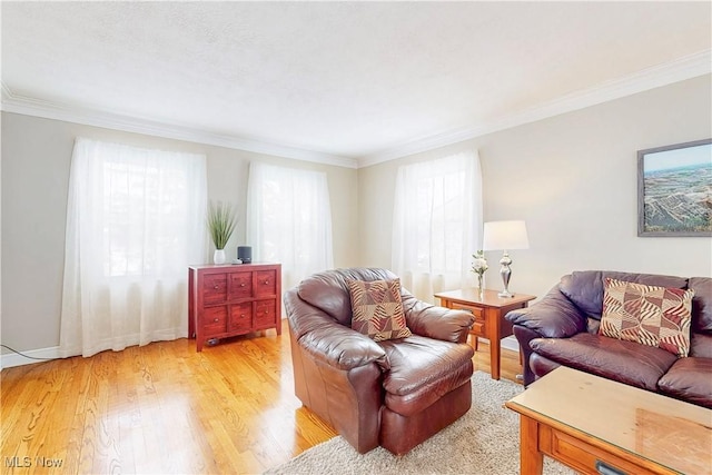 living area with ornamental molding and light wood finished floors