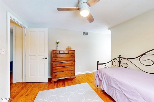 bedroom featuring visible vents, ceiling fan, light wood-style flooring, and baseboards