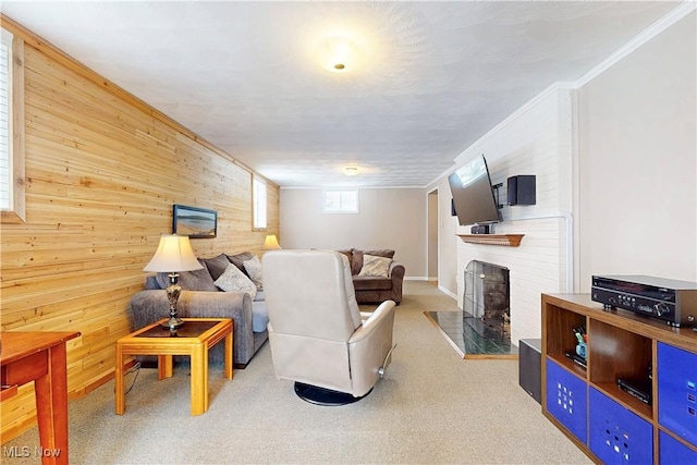 living room featuring light carpet, wooden walls, a fireplace, and crown molding