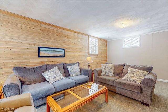 living area with carpet floors and wood walls