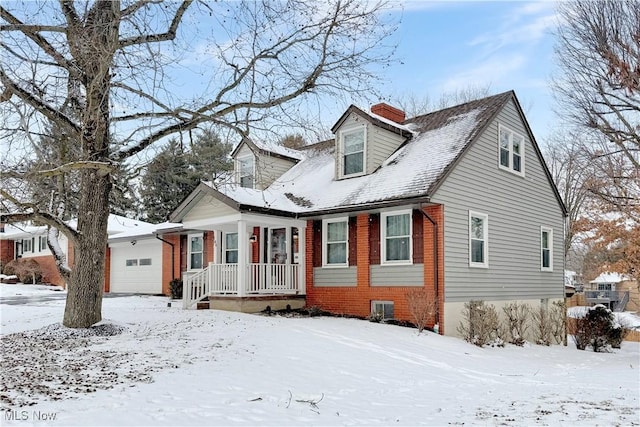 new england style home with an attached garage, a chimney, central AC, and brick siding